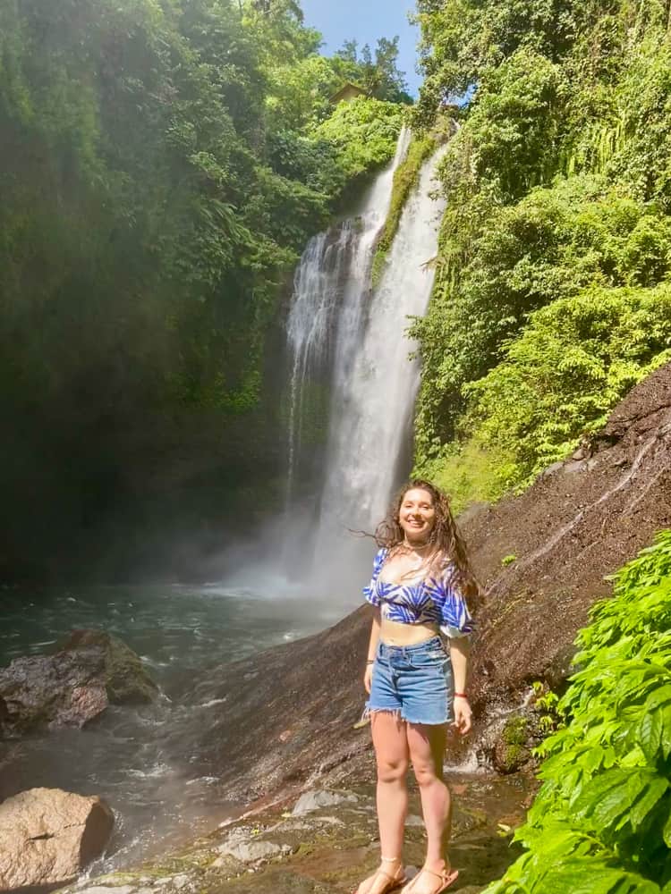 Blogger Katie Caf standing in front of aling aling waterfall in North Bali.