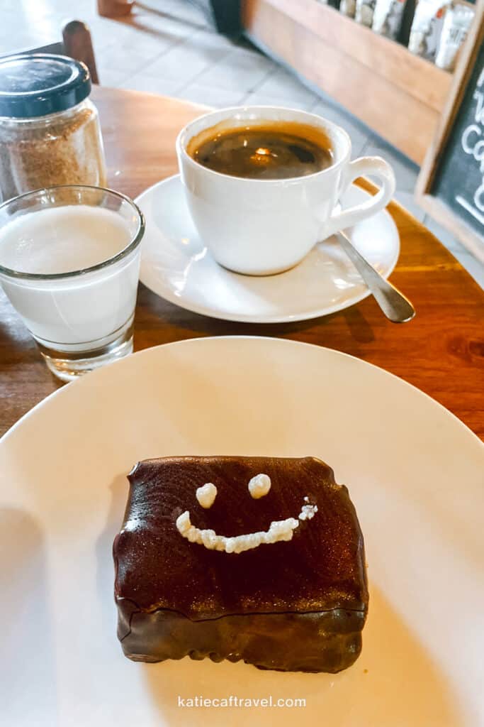 Chocolate dessert with a icing smiley face drawn on it