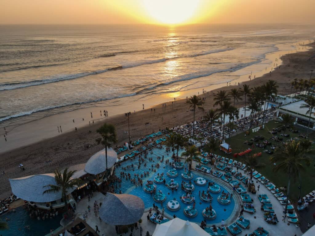 Finns Beach club in Canggu, Bali, photographed at sunset via drone.